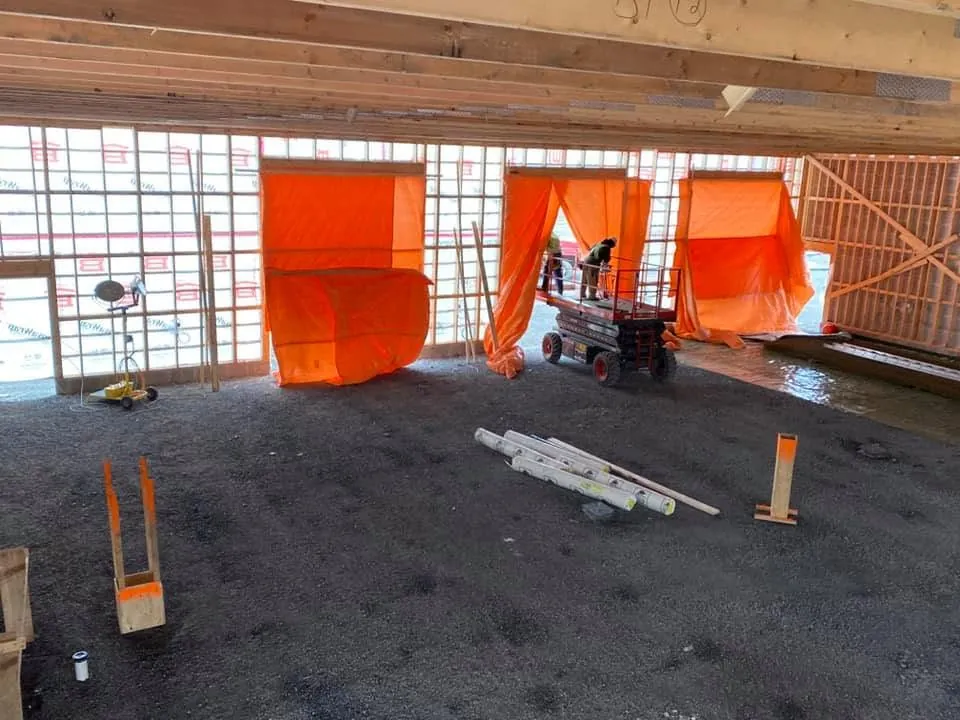 Wide view of electrical rough-in work in a large commercial interior.