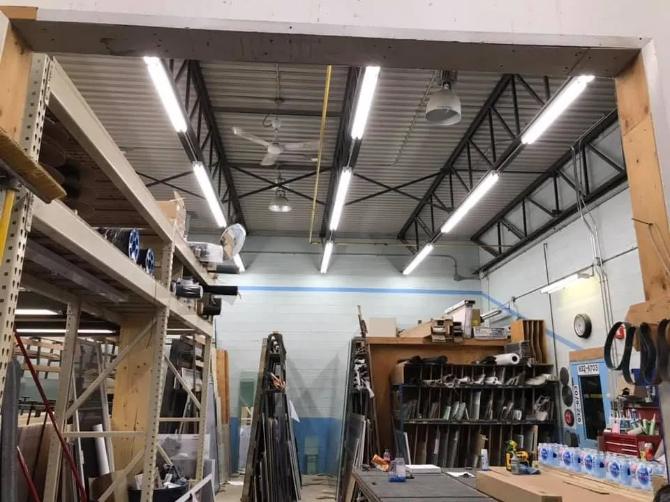 LED lighting above shelving and work areas in a commercial workshop.