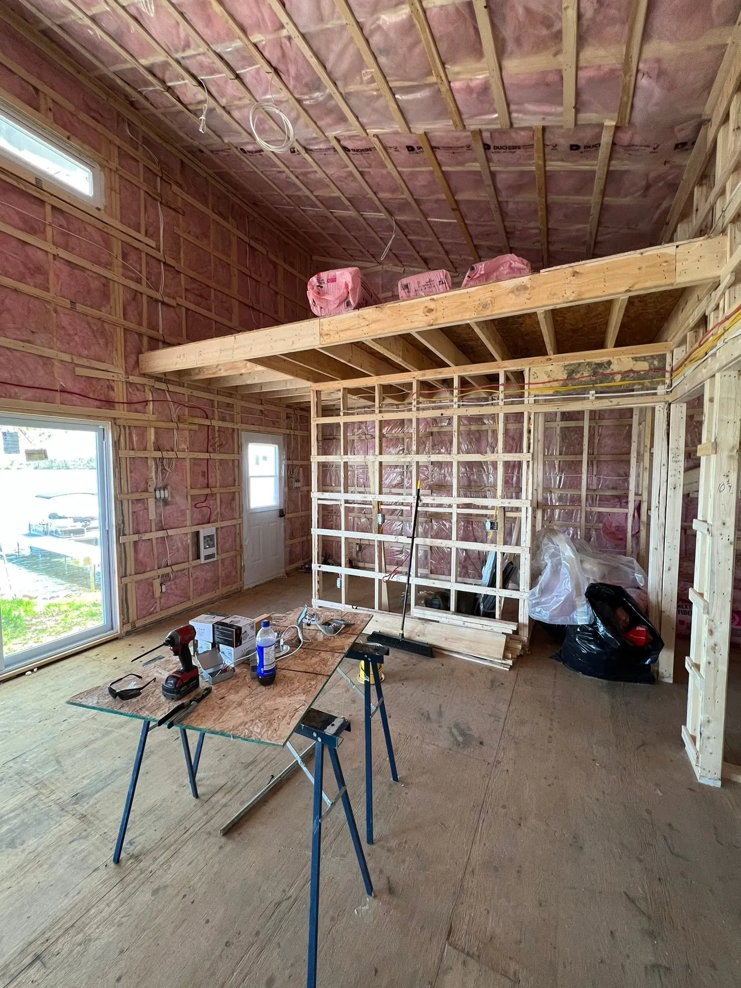 Electrical rough-in underway inside the framed walls of a custom home.