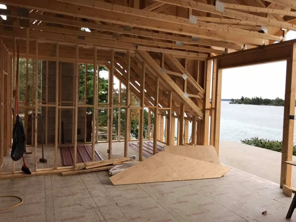 Electrical rough-in inside a framed lake house overlooking the water.