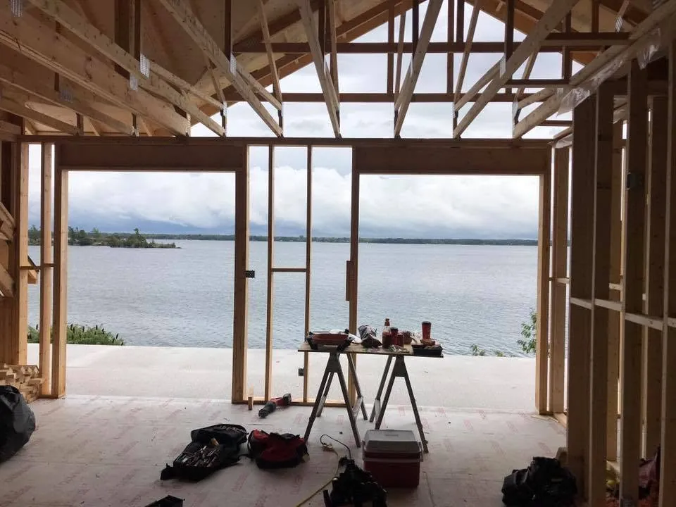 Vaulted lakefront room framed and prepared for electrical wiring and lighting.