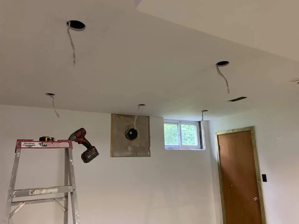 Ceiling openings and wiring prepared for residential pot lights.