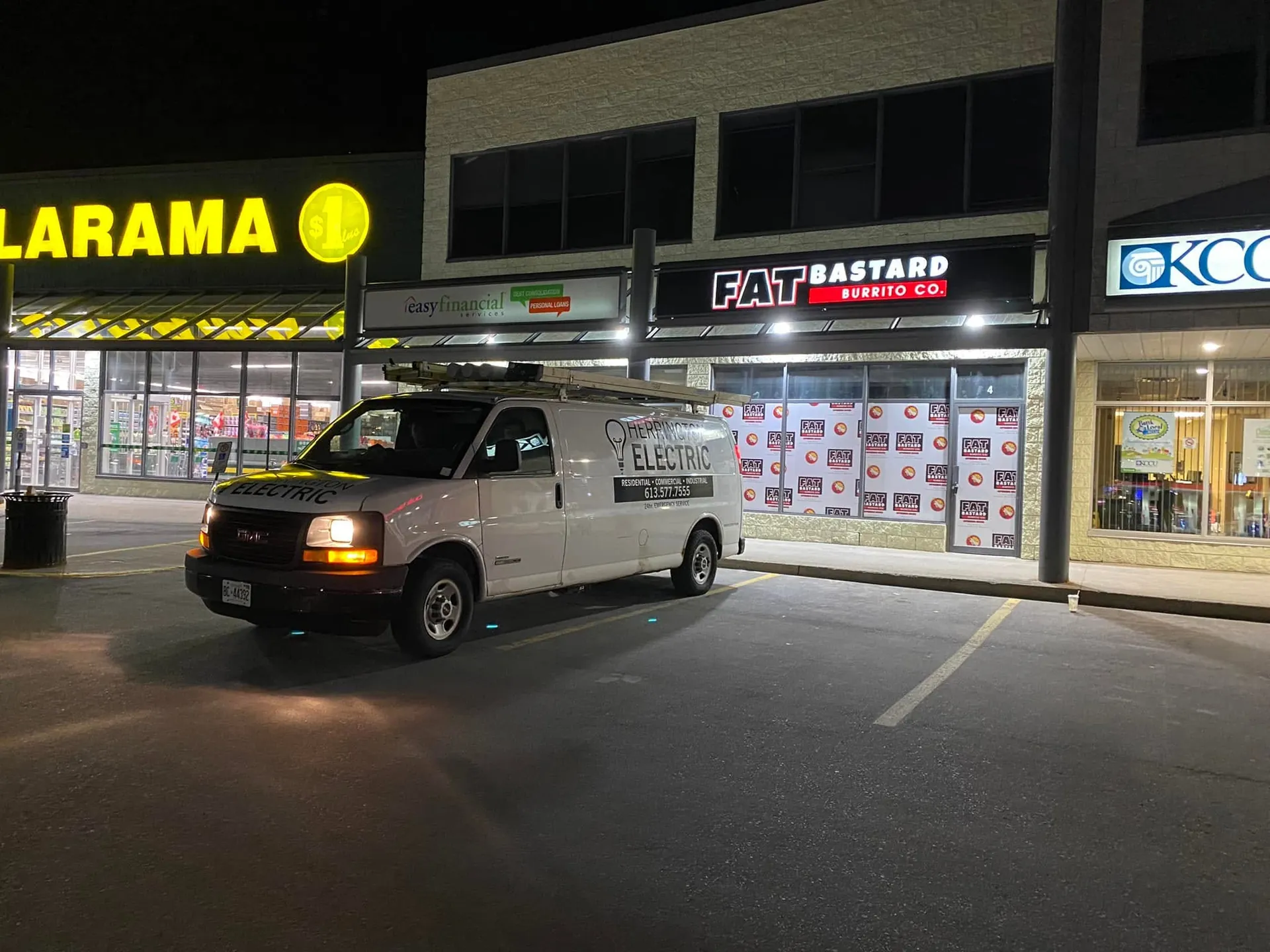 Herrington Electric van outside an illuminated retail plaza at night.