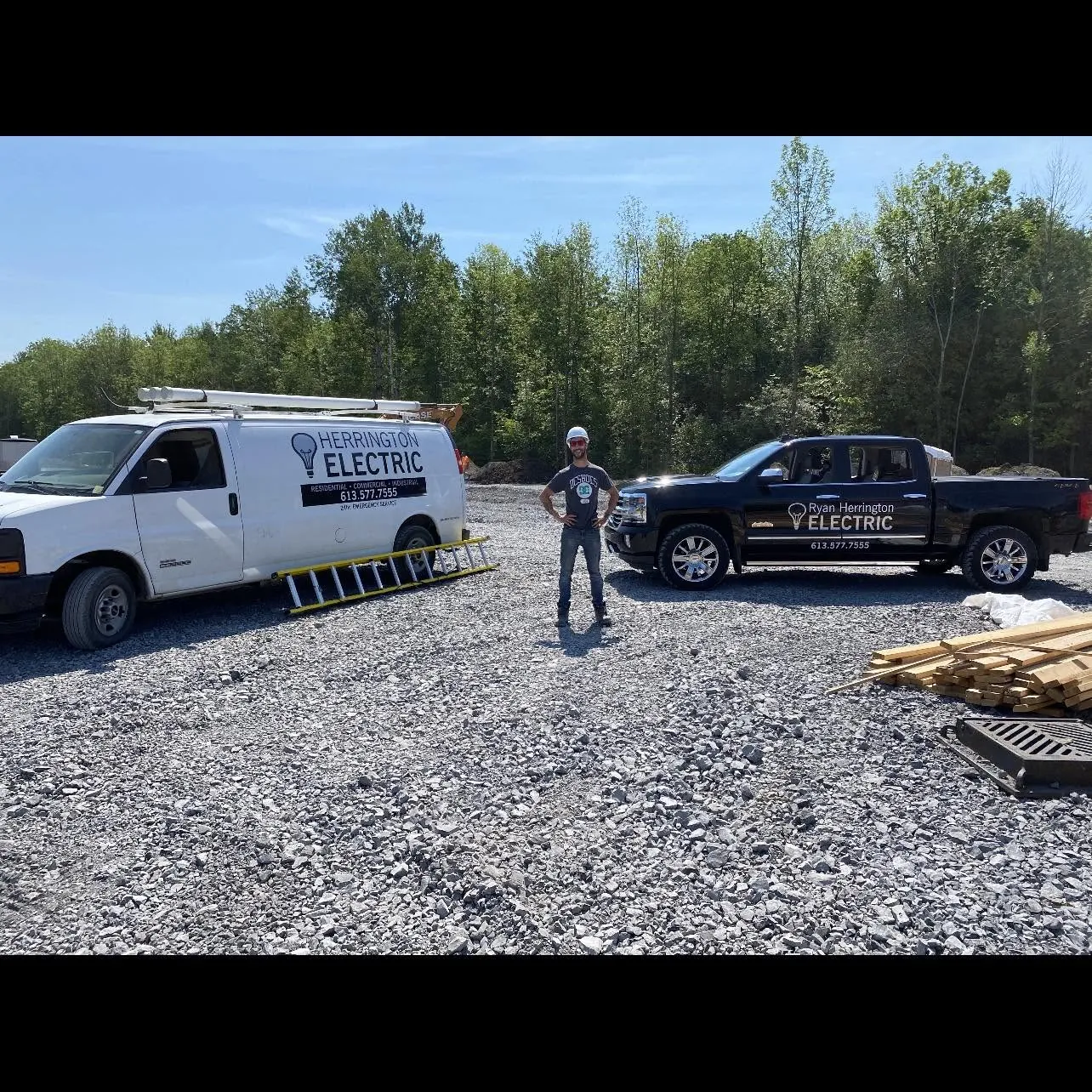 Ryan Herrington with branded service vehicles on a job site
